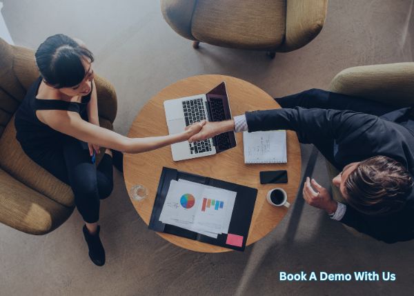 Final Expense Insurance Leads Photo of two people shaking hand at the office table with a laptop on top 